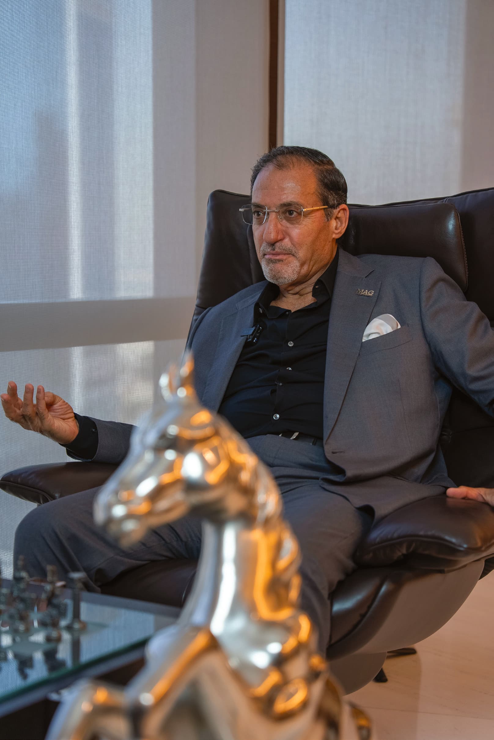 Moafaq A. Al Gaddah seated in a reflective interview setting.